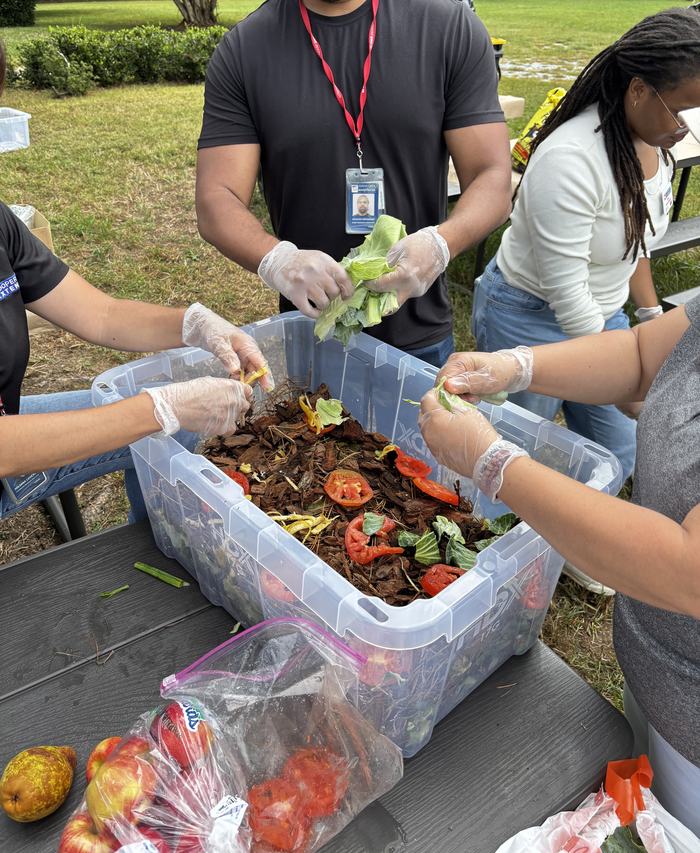 A group breaks down food scraps to use in composting.