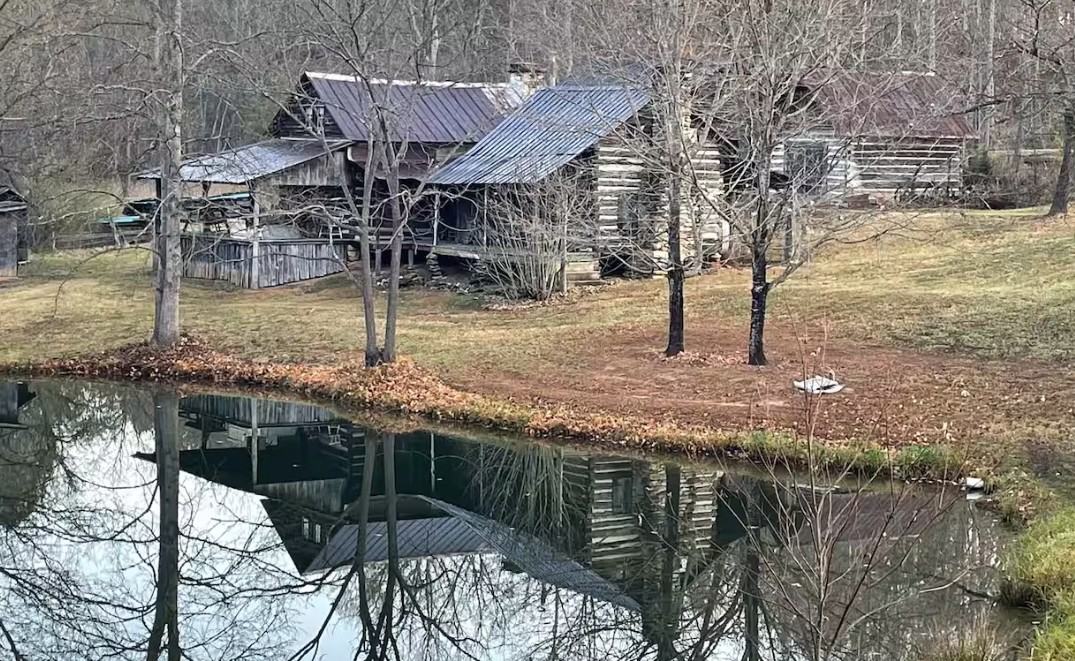 A farmstead beside a pond.