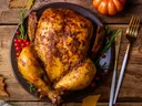 Roasted turkey on plate with small pumpkins