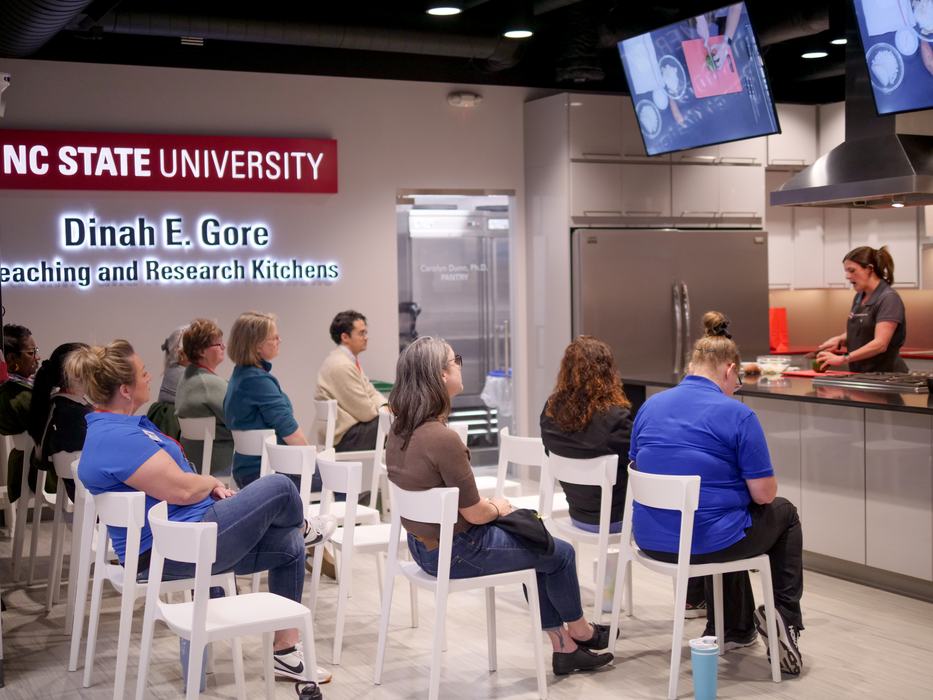 NC EFNEP Educators watching a knife skills demo