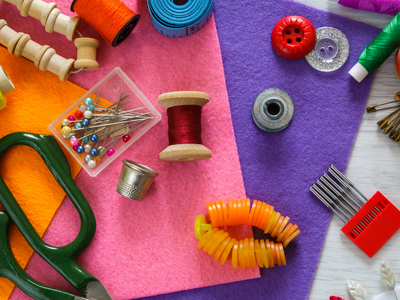 Sewing supplies on colorful felt with NC Cooperative Extension logo