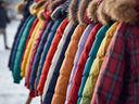 row of colorful children's coats against winter background