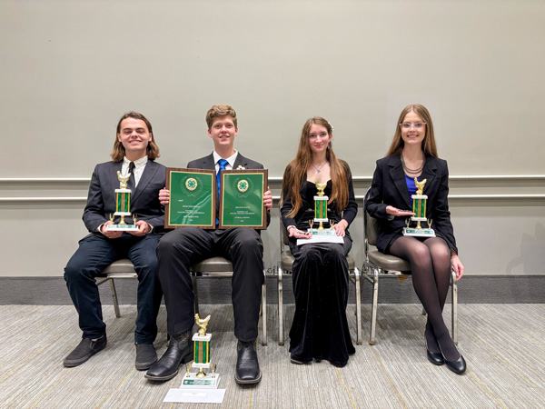 winning group holding trophies