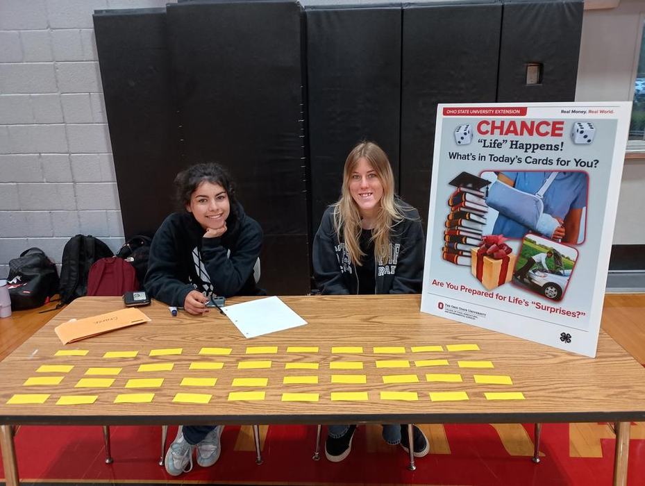 two girls sitting at an activity table