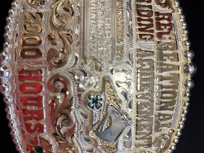 Ornate engraved belt buckle reading "Reserve Champion" and "2000 ROPERS"