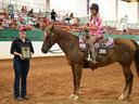 Young rider on horse #425 receiving a plaque reading 'Junior Sportsmanship Award'