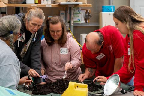 Participants in the Therapeutic Horticulture_s Open Community Social Group learn about Vermicomposting while getting hands-on experiences (photo courtesy of Megan Sweeney)