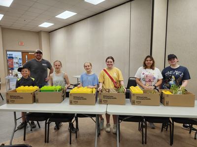 6 youth stand tall with their Day camp Leader all with smiles on their faces.