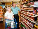 Photo of an elderly man and woman shopping for groceries.