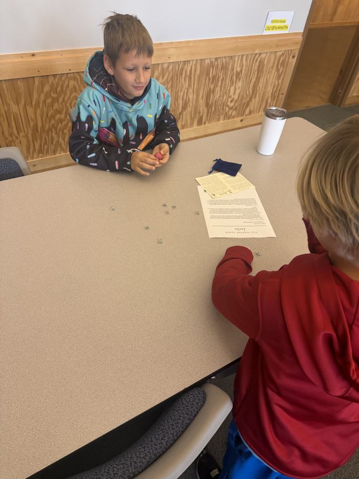 Youth playing colonial game name jacks