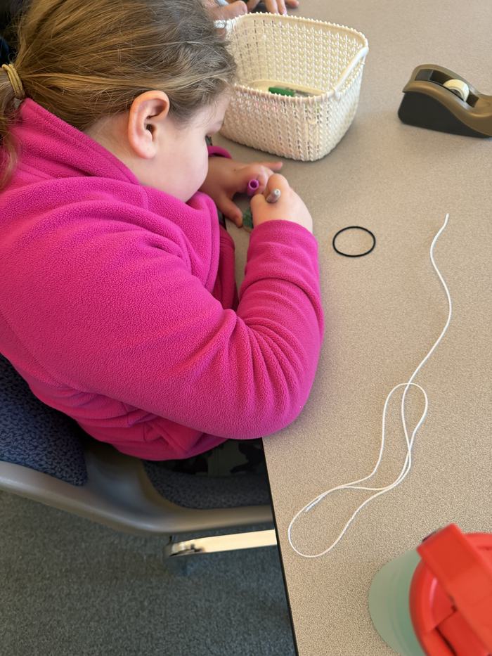 Youth using markers to make colonial toys to play with