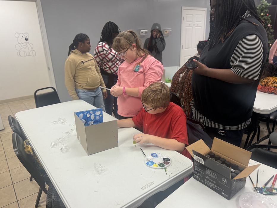 Kids work to decorate a diorama.
