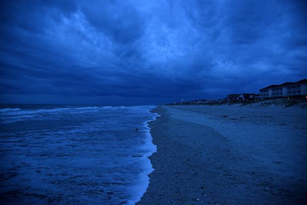 Storm clouds roll across Ocean Isle at dawn.