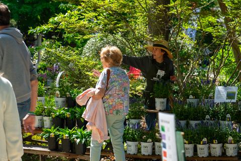 Extension Master Gardener volunteer assisting customer in finding plants