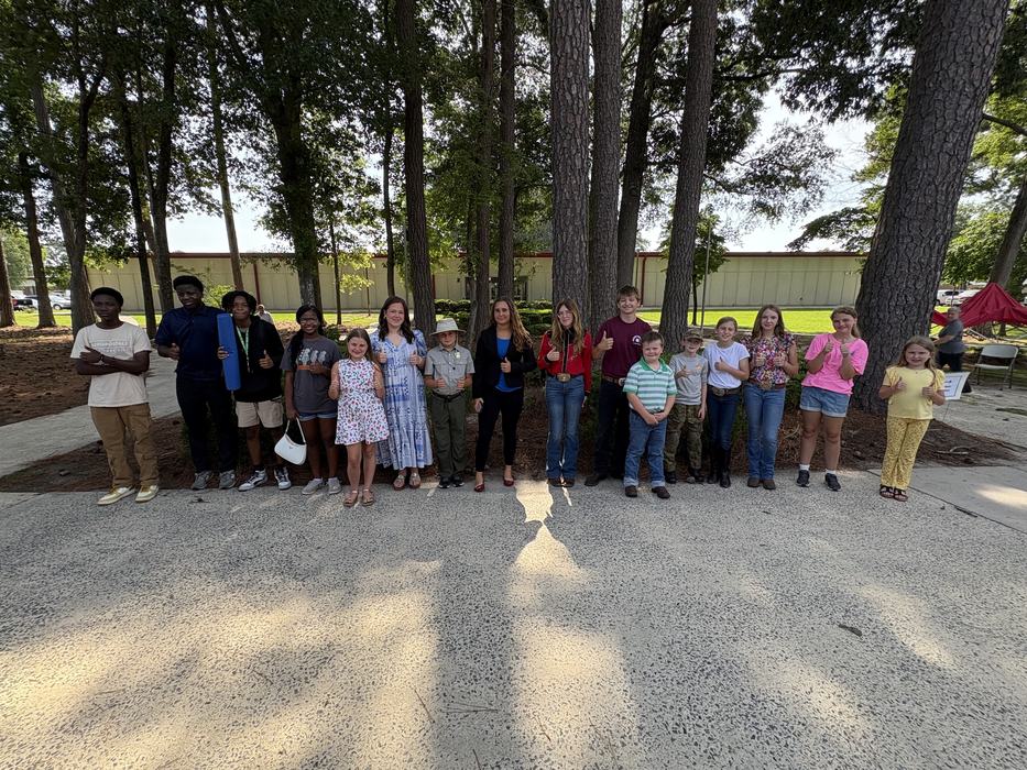 Youth standing in front of trees