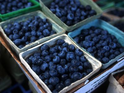 Cardboard pint containers filled with blueberries at a market stand
