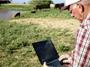 A farmer working on his computer used as an example to show the use of AI in local food work.
