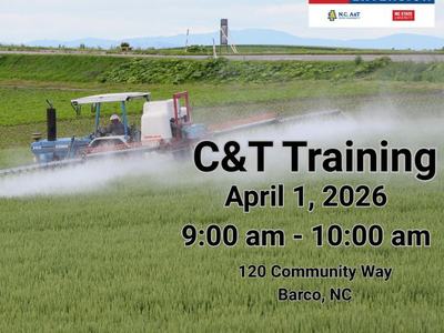 Tractor spraying a field