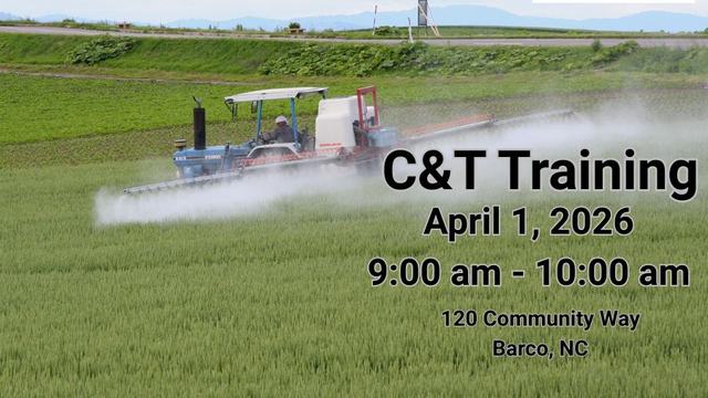 Tractor spraying a field