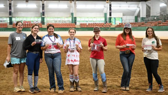 A group of youth with their 2025 recreational riding rewards awards in the main arena of the Hunt Horse Complex.