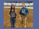 The senior and junior sportsmanship award winners posing with their plaques in the main arena of the Hunt Horse Complex.