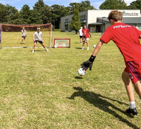 Soccer player kicks a goal