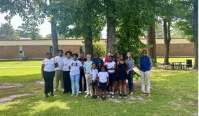 Group of Halifax County 4-H youth participants and adult leaders standing together outdoors under a large tree at District Activity Day.