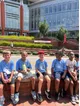 Halifax County 4-H youth participants sitting together outdoors during a field trip to NC State University's athletic facilities in Raleigh, North Carolina.