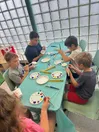 Children gathered around a table participating in hands-on plant-themed activities during Plant Palooza, a partnership between Halifax County 4-H and a local library.