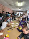 Children gathered around tables participating in hands-on educational activities and crafts during a field trip hosted by Halifax County 4-H.