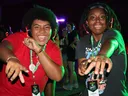Two 4-H members wearing LED headphones point toward the camera while participating the silent disco at 4-H Congress.