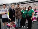 Youth from the NC State Extension 4-H program in Harnett and Moore counties stand in front of a race truck at Charlotte Motor Speedway