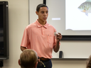 A 4-H'er giving a presentation on fishing.
