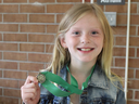 4-H'er holding a gold medal that she was awarded for her presentation at state finals.