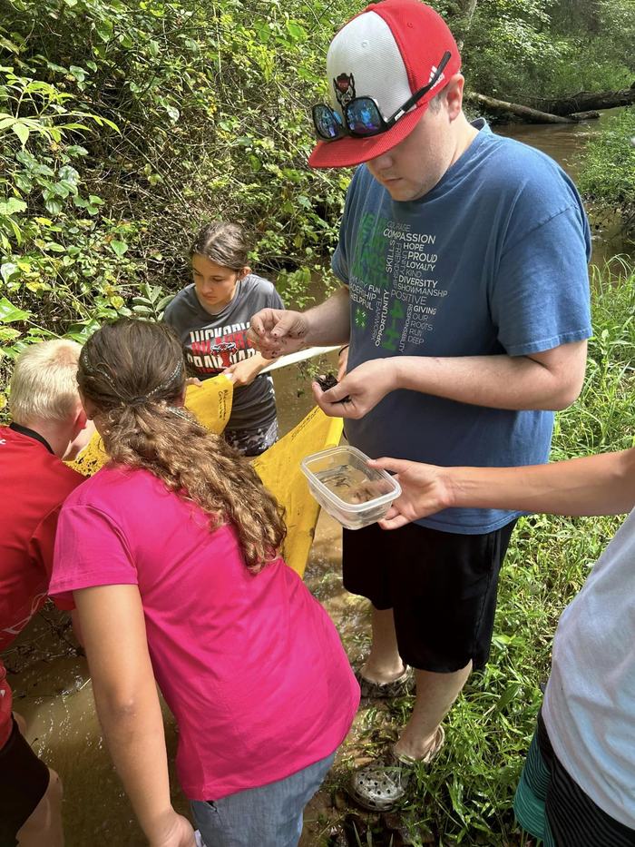 image from summer program 4-H20.  4-H agent and youth are doing an activity