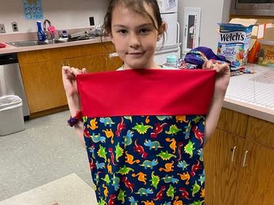 4-her holding pillowcasae
