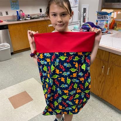 4-her holding pillowcasae