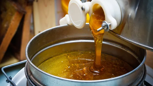 Honey pouring into barrel