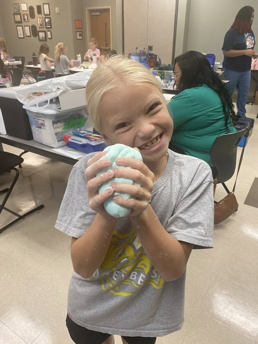 Cloverbuddies member holding a science project.