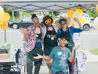 Four Master Gardeners posing in insect masks at a Pollinator Census event