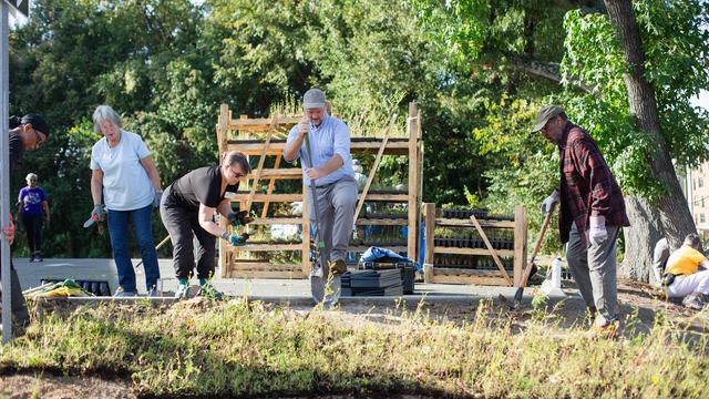 Gardening experts install plants at Cooperative Extension.