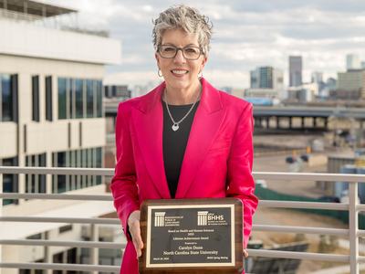Dr. Carolyn Dunn holding her award