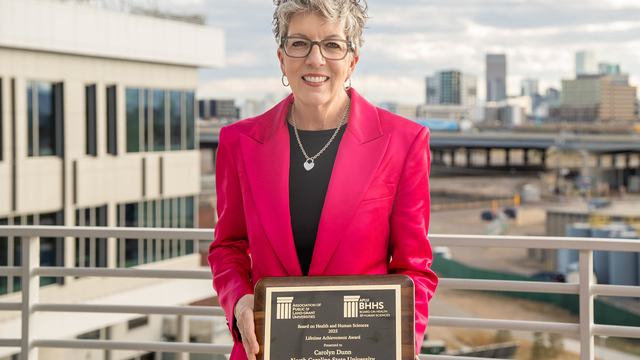 Dr. Carolyn Dunn holding her award