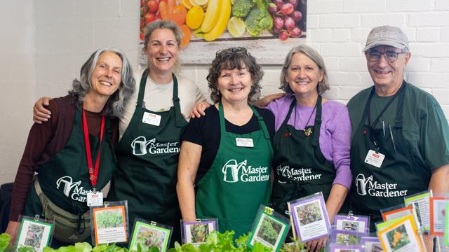 EMG volunteers of Durham County with healthy plants they grew smile and welcome the public to learn about sustainable gardening.