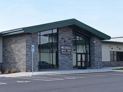 An image of the front entrance of the North Carolina Cooperative Extension, Forsyth County Center building in Tobaccoville, North Carolina.