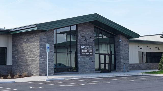 An image of the front entrance of the North Carolina Cooperative Extension, Forsyth County Center building in Tobaccoville, North Carolina.