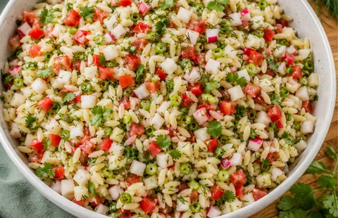 bowl of orzo with chopped veggies