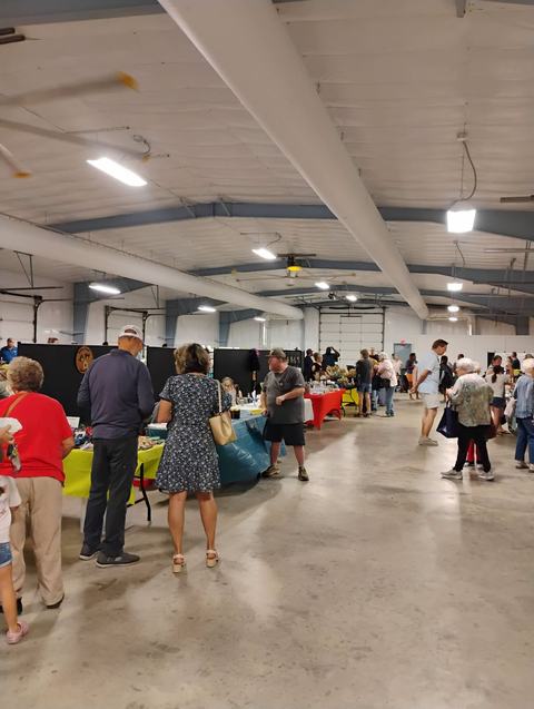 Customers visiting vendors at the farmers market