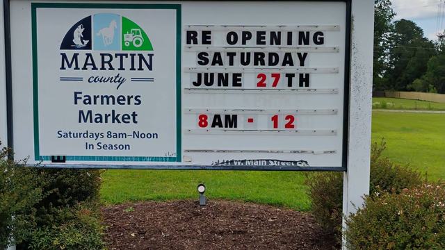 Marquee sign outside Farmers Market with Grand Re-opening date