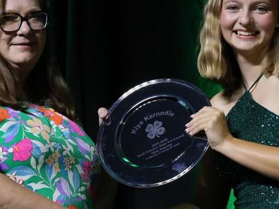 Kiya Kernodle receiving her commemorative plate as she completes her term as a state officer